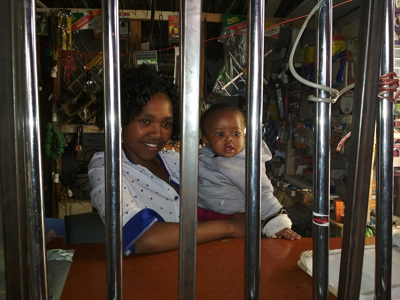 A Kenyan shopkeeper working in an electrical hardware shop